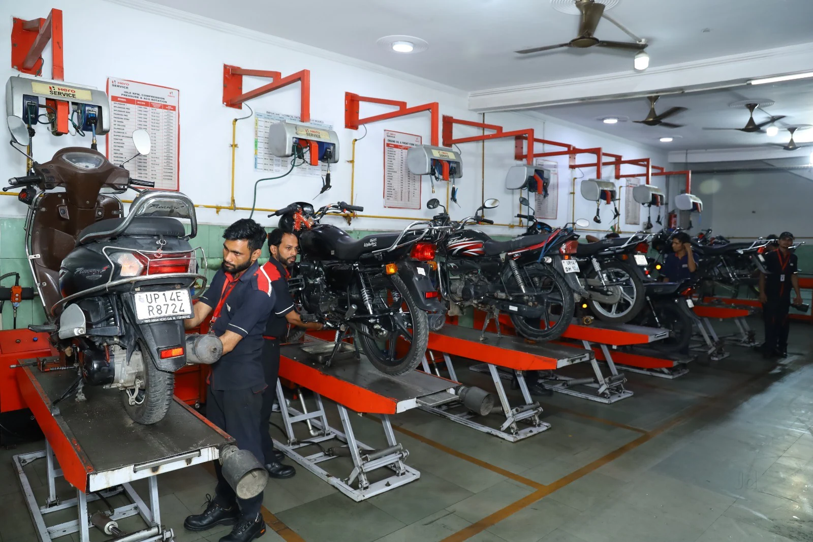 Hero motorcycles lined up inside a service workshop